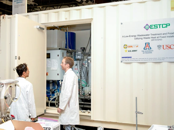 Two scientists talking at West Center