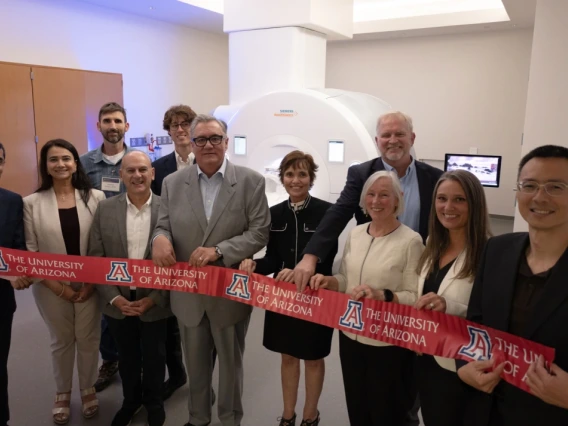 ribbon-cutting ceremony in front of MRI machine