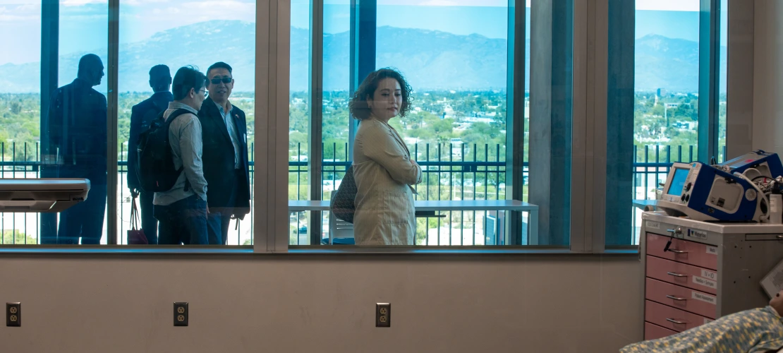 Attendees of healthcare delegation walking through the Astec Lab.