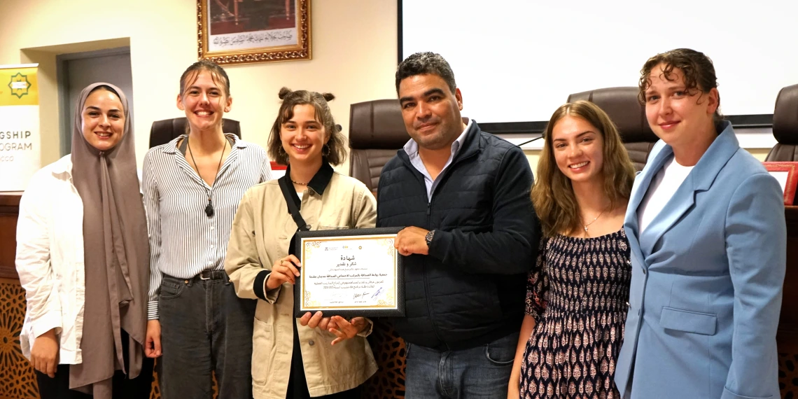 Row of students and certificate in Arabic